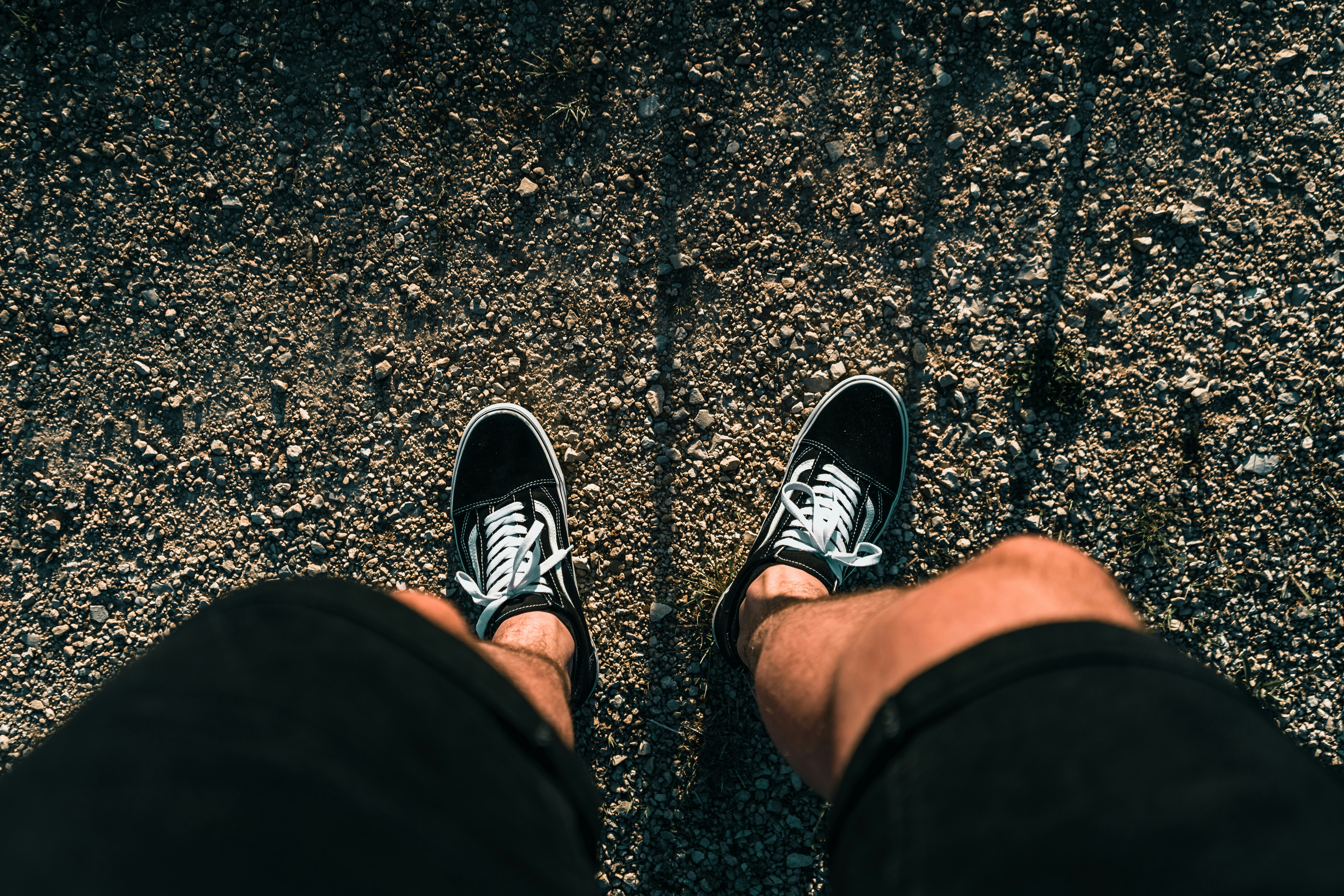 person wearing black and white sneakers